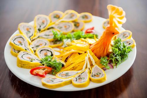 a white plate of food on a wooden table at Muong Thanh Grand Ha Tinh Hotel in Kỳ Anh