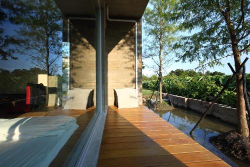a house with glass walls and a wooden deck at Chuying Sunrise B&B in Jian