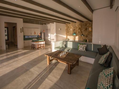 a living room with a couch and a table at Beach House in Vilanculos