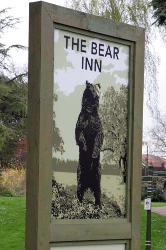 a poster of a bear in a sign at Bear Inn, Somerset by Marston's Inns in Street