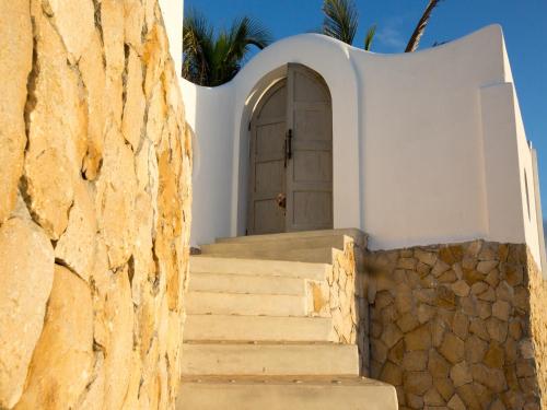 a door to a building with stairs in front at Beach House in Vilanculos