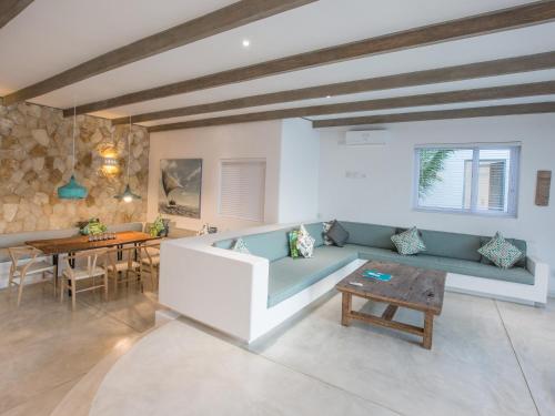 a living room with a blue couch and a table at Beach House in Vilanculos
