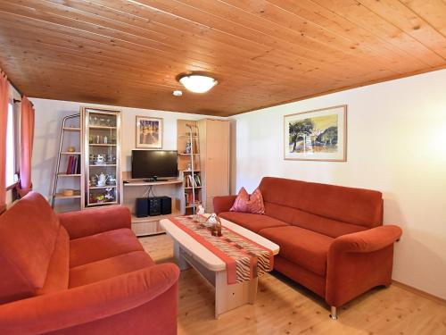 a living room with two couches and a tv at Holiday home in Rattersberg Bavaria with terrace in Viechtach