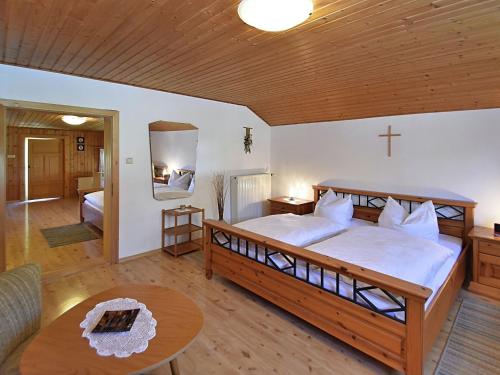 a bedroom with a large bed with a cross on the wall at Holiday home in Rattersberg Bavaria with terrace in Viechtach