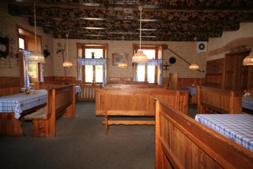 a large room with wooden pews in a church at Pension Harcovna in Frýdlant nad Ostravicí