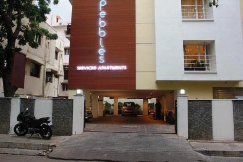 a motorcycle parked in front of a building at Pebbles in Chennai