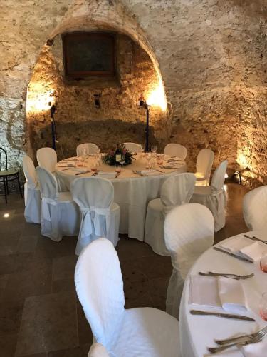 a dining room with white tables and white chairs at Villa San Liberale - Suites & Wellness - Villa Veneta in Feltre