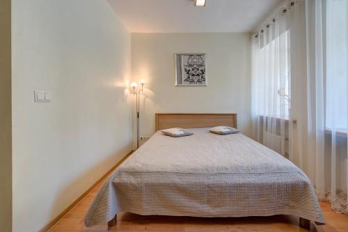 Ένα ή περισσότερα κρεβάτια σε δωμάτιο στο Vidos Apartamentai
