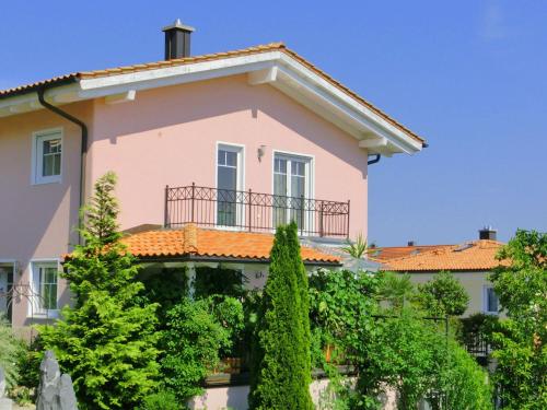 a pink house with a balcony at Apartment near the river in Deggendorf Bavaria in Deggendorf