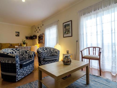 a living room with two chairs and a table at This warm and comfortable apartment is located just outside the city of Lagos in Lagos