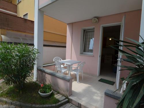 a small patio with a table and chairs on a house at Belvilla by OYO Lido Estensi Bilo Doria in Lido degli Estensi