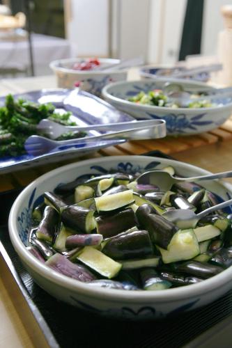 a bowl of vegetables on a table with other dishes at Kansyokan in Mogami