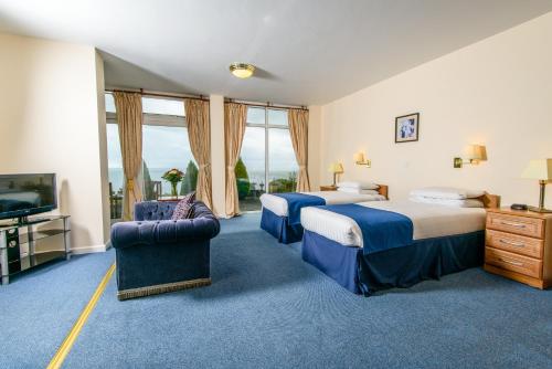 a hotel room with two beds and a flat screen tv at Ocean View Hotel in Shanklin
