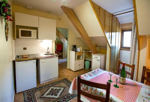 a kitchen and dining room with a table with a tableablish at Gites Les Cépages in Ammerschwihr