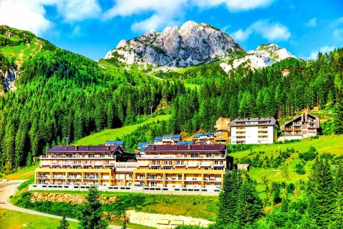 a resort in the mountains with mountains in the background at Appartements Nassfeld LUX in Sonnenalpe Nassfeld