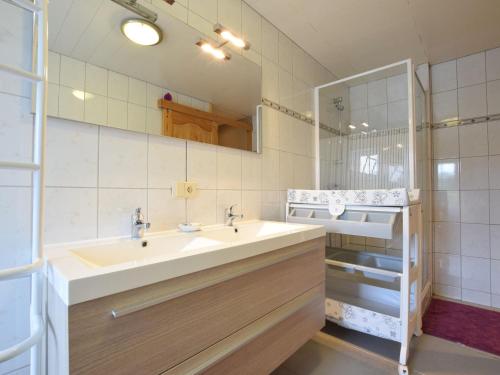a bathroom with a sink and a mirror at Furnished Holiday Home in Tillet with Private Terrace in Gérimont