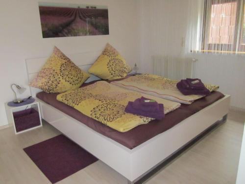 a bed with pillows on it in a bedroom at Ferienwohnung Bambusgarten in Mössingen