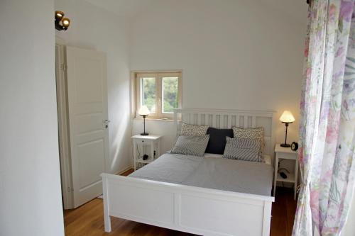 a white bed in a room with a window at Holiday Home Nevista in Sumartin