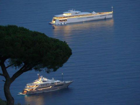 a cruise ship and a large boat in the water at Villino L'Aranceto Sorrentino in Meta