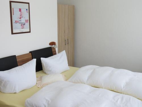 a bedroom with two beds with white pillows at Hotel-Pension SCHLOSS -MIRAMAR in Bad Elster