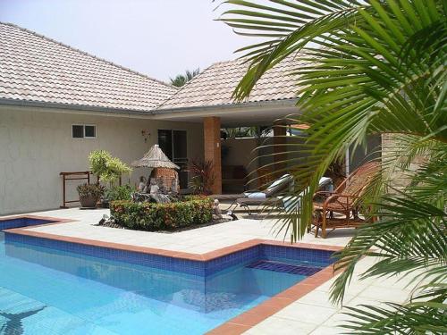 a house with a swimming pool in front of a house at Villa Baansiesom in Sam Roi Yot