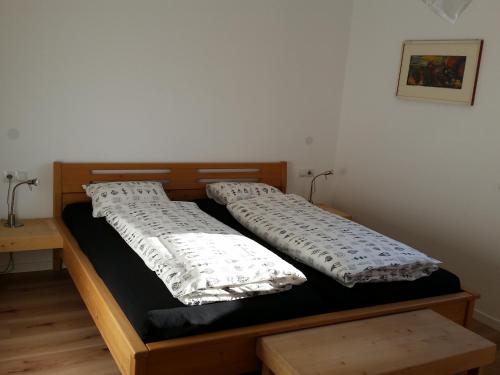 a bed with two pillows on top of it at Ferienwohnung Palma in Termeno
