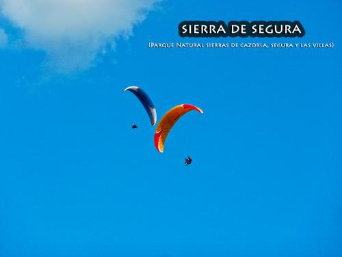 two kites flying in the blue sky at La Vieja Parra in La Puerta de Segura