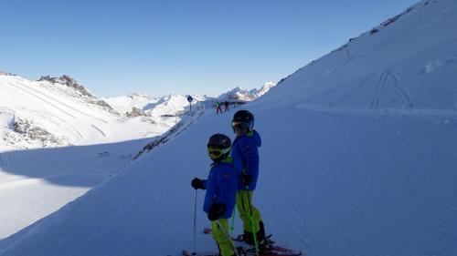 two people on skis standing on a snow covered slope at FEWO "Unterm Wald" in Stumm