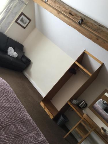 a room with a bed and a couch at The Huntsman in Cheadle
