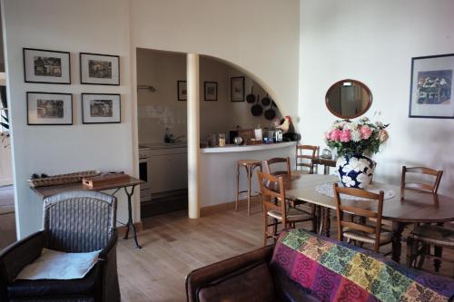 a kitchen and dining room with a table and chairs at les crépinières in Chartres