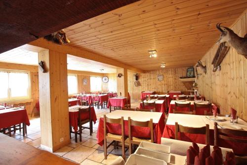 プラ・ルーにあるAppartement Auberge de Pra Loupのテーブルと椅子が備わるレストラン