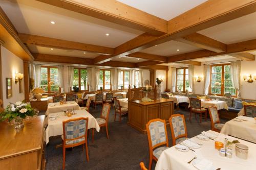 a restaurant with tables and chairs in a room at Landhotel Donner in Meschede