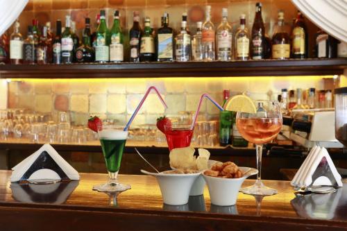 a bar with glasses of wine and some food at Hotel Piccadilly in Lido di Camaiore