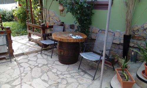 a wooden table and chairs in a patio at Casa Cosmin in Dobra