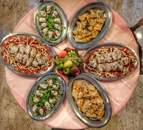a table topped with bowls of different types of food at Hotel Al Caminetto in Valtournenche