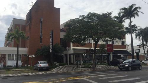 a street with cars parked in front of a building at Ancona Center Hotel in Amparo