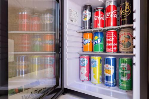 a refrigerator filled with lots of cans of soda at Dolce Luxury Rooms in Rome