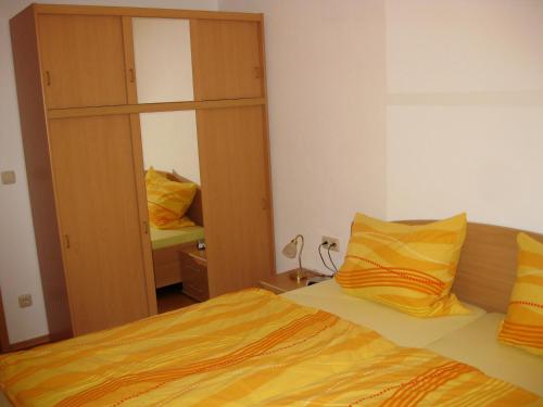 a bedroom with a bed and a large mirror at Ferienwohnung Meyer in Schönwald