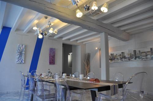 a dining room with a long table and chairs at Chambre d'hôtes Sauternais in Pujols-sur-Ciron