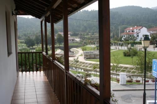 a balcony with a view of a golf course at Casa de Sao Cristovao in Boticas