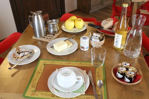 a wooden table with plates of food on it at La Pietra Felice in Introd