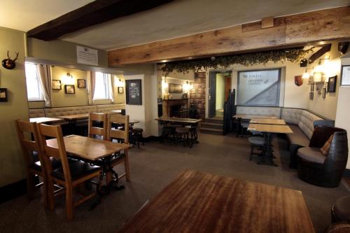 a restaurant with tables and chairs and a bar at Church Inn in Ludlow