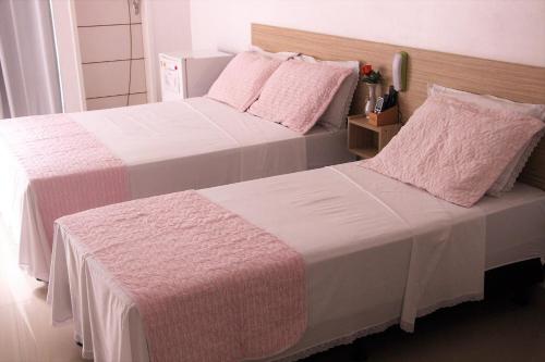 two beds sitting next to each other in a bedroom at Hotel Marajoara in Belém