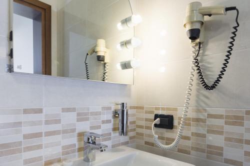 a bathroom with a sink and a phone on the wall at Park Hotel Ristorante Ca' Bianca in Istrana