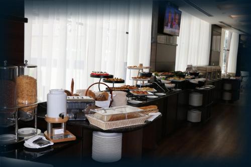 a buffet line with many different types of food at Orange Suites Hotel in Manama