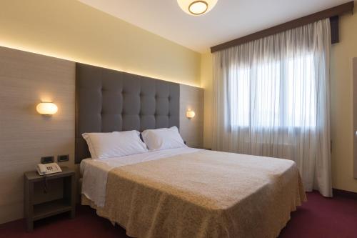 En eller flere senge i et værelse på Park Hotel Ristorante Ca' Bianca