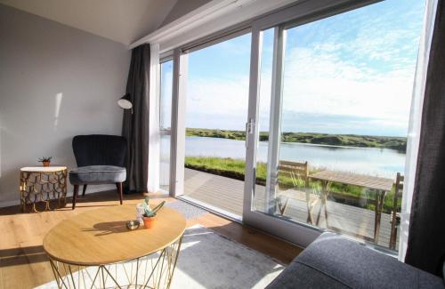 a living room with a view of the water at Magma Hotel in Kirkjubæjarklaustur