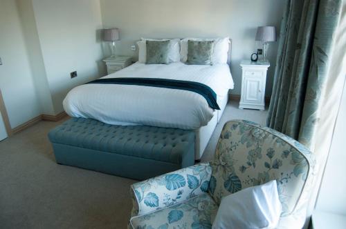 a bedroom with a bed and a chair and a chair at Castle View Guesthouse in Durham