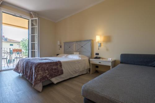 a bedroom with a bed and a window with a view at Hotel Villa Cappugi in Pistoia