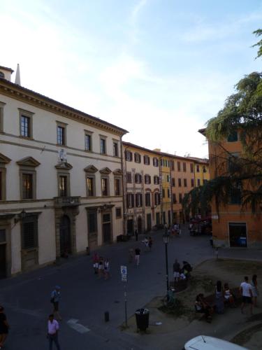 a group of people sitting in a courtyard in a building at Time Out in Pisa